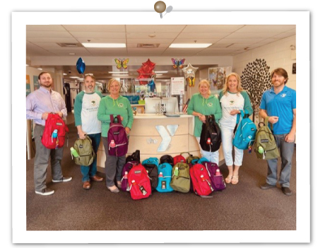 Ipswich YMCA employees receiving camper backpacks